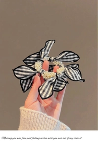 Detail of checkered and striped bows with pearls on a hair scrunchie accessory