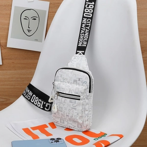 Detail of white crossbody chest bag featuring grey letter prints and a black logo strap
