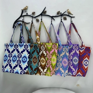 Collection of large canvas tote bags with Ikat ethnic patterns and colorful woven handles