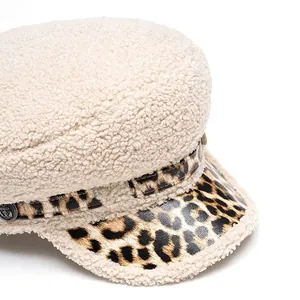 Faux lamb wool newsboy cap in cream with leopard print brim and vintage anchor button detail