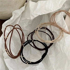 Three-layer elastic hair ties with gold beads in brown, black, beige, and pink tones