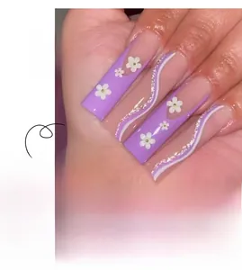 Detail of purple long coffin press-on nails with 3D floral accents and silver glitter wavy lines