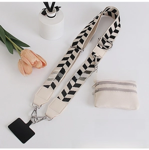 Detail of leaf pattern crossbody phone strap with detachable cream coin purse and metal buckle