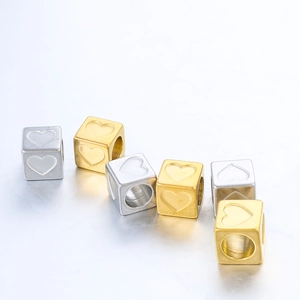 Macro view of 6mm stainless steel square beads with engraved heart patterns for DIY jewelry