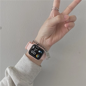 Pink digital sports watch featuring a square LED screen and silver chain pendant detail