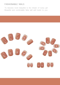 Detail of short square-round press-on nails with pink gradient and gold foil flakes