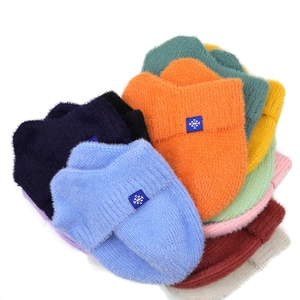 Colorful plush winter knit hats for women with snowflake patches in various bright shades