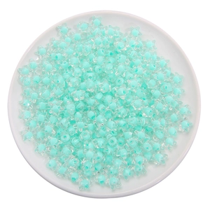 Star-shaped turquoise acrylic beads for DIY handmade jewelry on white tray