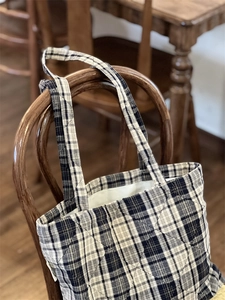 Detail of British style quilted plaid cotton tote bag with soft inner lining