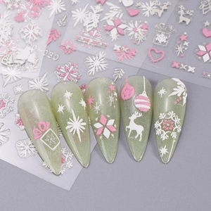 Detail of Christmas nail art stickers with pink snowflakes, deer and 3D embossed stars