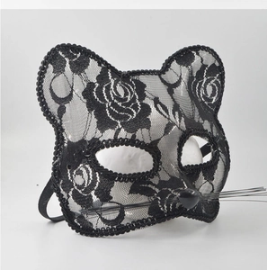 Detail of black lace cat mask with floral patterns and flexible elastic headband for cosplay