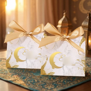 Detail of Eid Mubarak gift bags with marble pattern and gold foil moon graphics