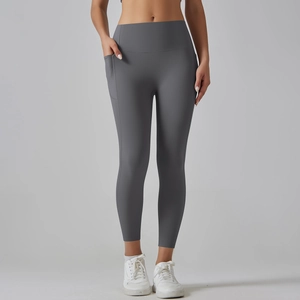 Detail shot of high waisted gray yoga leggings featuring a practical side pocket for phone