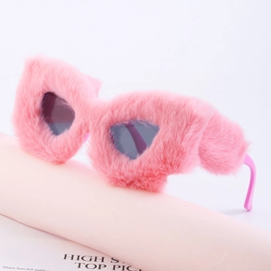 Chic pink fuzzy faux fur heart-shaped sunglasses displayed on a matching pink pedestal