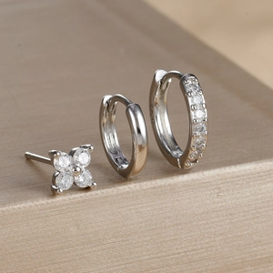 Detailed macro view of S925 sterling silver clover studs and zircon hoop earring set