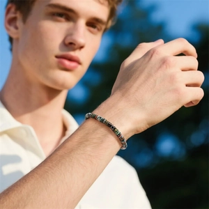 Natural agate and magnetic stone disc bead bracelet worn by a model in sunlight