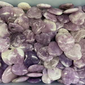 Macro shot of 2cm purple heart-shaped natural crystals with smooth texture and gloss