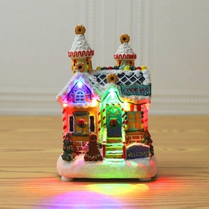 Detail of Christmas gingerbread house with colorful LED lights and snow effect