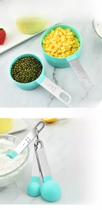 Detail view of mint green silicone measuring cups with stainless steel handles for baking