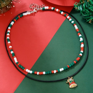 Detail of Christmas double-layer necklace with seed beads and festive bell pendant