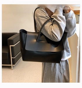 Minimalist black matte leather tote bag with large capacity and slim shoulder straps