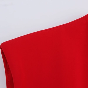 Macro view of red woven fabric detail showing the V-neckline texture of the women's vest