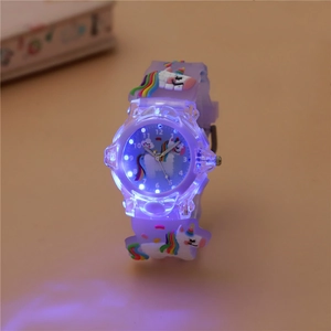 Close-up of children's unicorn watch featuring glowing purple LED lights on the strap