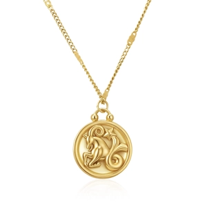 Close-up of gold-plated circular pendant featuring Capricorn zodiac relief on fine chain