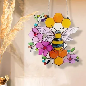Colorful acrylic bee suncatcher with honeycomb and flowers hanging on a metal chain