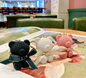 Three cute resin knit-texture bear keychains in pink, white, and dark green with bows