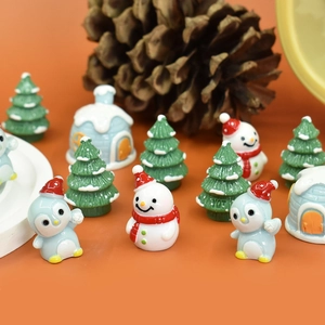 Detailed view of assorted Christmas miniature resin figurines on an orange background