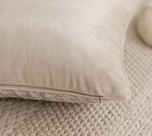 Macro shot of invisible zipper detail on beige velvet throw pillow cover