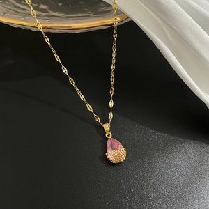 Vue détaillée du pendentif en cristal rose avec motif floral ajouré en or