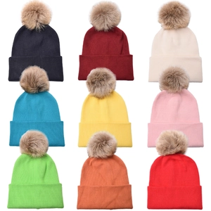 Winter knit hats with fur pom poms in nine assorted colors for men and women