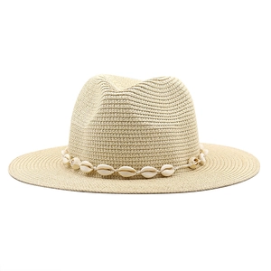Detailed weave of a straw Fedora sun hat with a decorative natural shell band