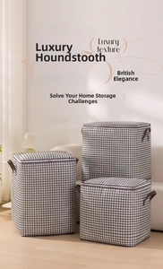 Detail of houndstooth storage bags featuring sturdy leather handles and zipper closure