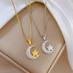 Minimalist titanium steel necklace featuring gold and silver moon and star pendants with crystals