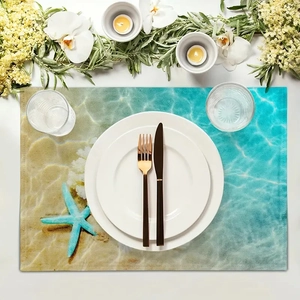 Flat lay of beach shell place mat with starfish design and blue water ocean pattern