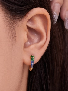 Detail showing 18k gold plated U-shaped huggie earrings with colorful zircon stones on ear