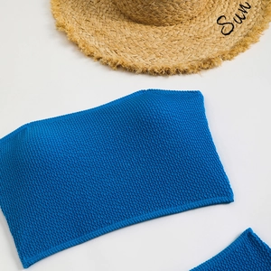Detailed macro view of royal blue popcorn textured fabric on a strapless bikini top