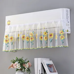 Detail of white mesh AC cover featuring vibrant sunflower embroidery and scalloped edges