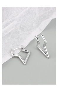 Detail view of silver geometric lightning earrings with polished metal finish on textured paper