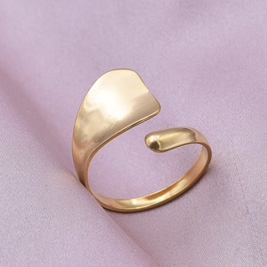 Minimalist gold adjustable geometric ring on elegant purple silk background with soft lighting