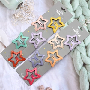 Macro detail of colorful star-shaped glitter metal hair clips on display cards