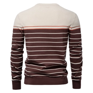 Detailed knit texture of a men's striped sweater with ribbed hem in cream and brown