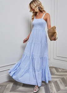 Detail of blue and white striped maxi dress showing pleated bust and tiered cake skirt