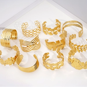 Collection of various gold-plated hollow flower and geometric stainless steel cuff bracelets