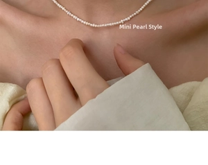 Close-up of elegant mini freshwater pearl choker necklace worn on a woman neck