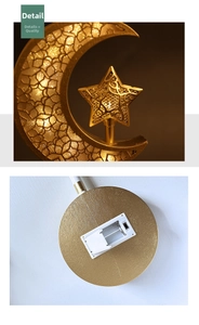 Detail of golden moon star LED lamp showing bottom battery compartment and power switch