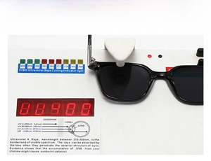 Detail view of black square sunglasses undergoing a professional UV400 protection test
